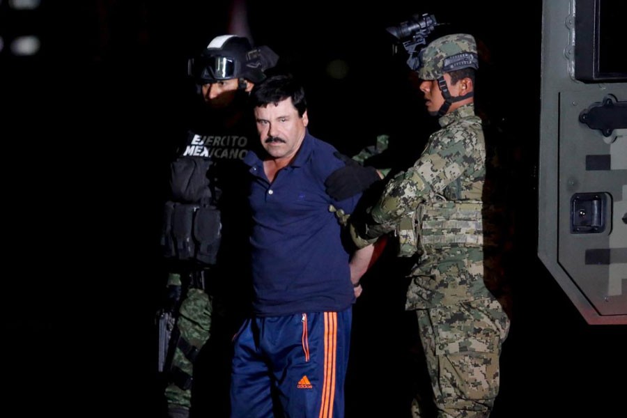 Joaquin "El Chapo" Guzman is escorted by soldiers during a presentation in Mexico City, January 8, 2016 - REUTERS/Tomas Bravo