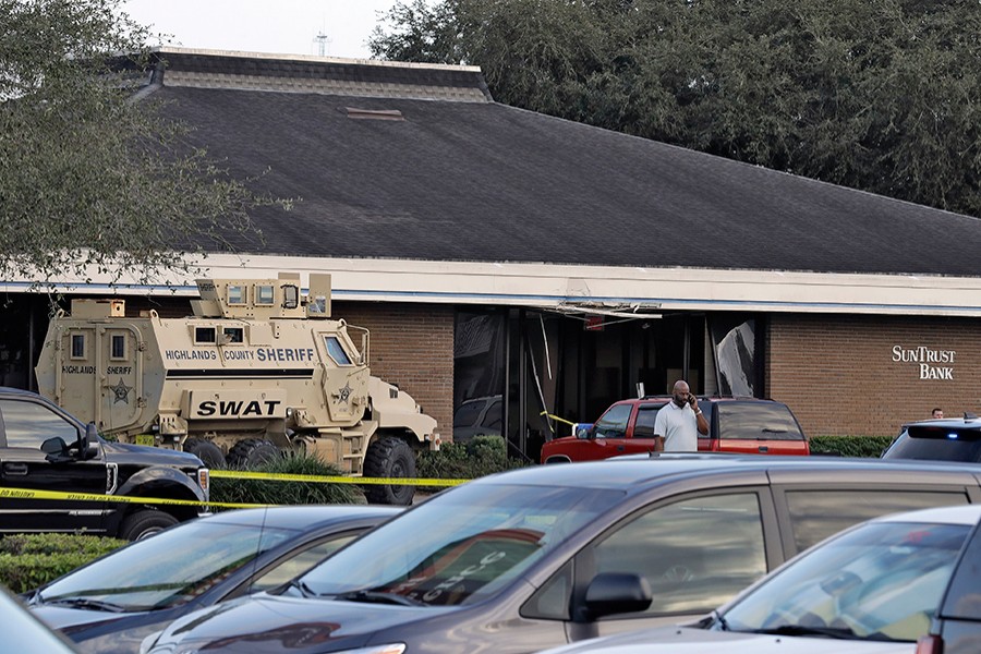 A Highlands County Sheriff's SWAT vehicle is stationed out in front of a SunTrust Bank branch on Wednesday in Sebring, Florida where authorities say five people were shot and killed — AP photo