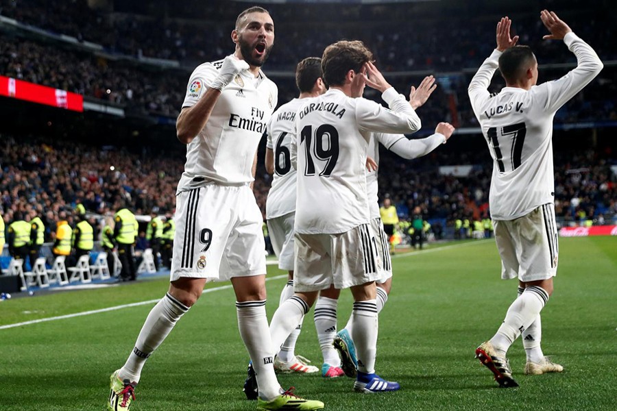 Real Madrid's Karim Benzema celebrates scoring their fourth goal with his teammates — Reuters photo