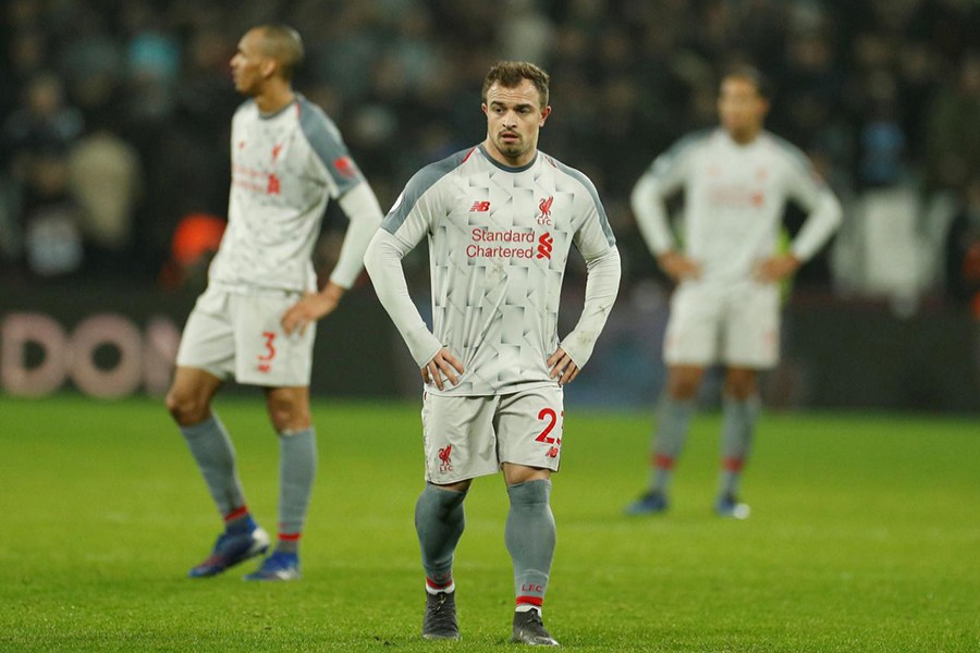 Liverpool's Xherdan Shaqiri (C) and Fabinho (L) cut dejected figures after the match — Reuters photo