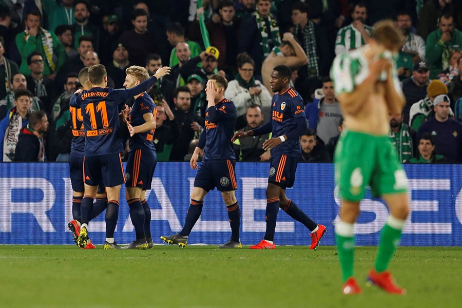 Valencia's Kevin Gameiro celebrates scoring their second goal as Real Betis' Sergio Canales looks dejected in this Reuters action image