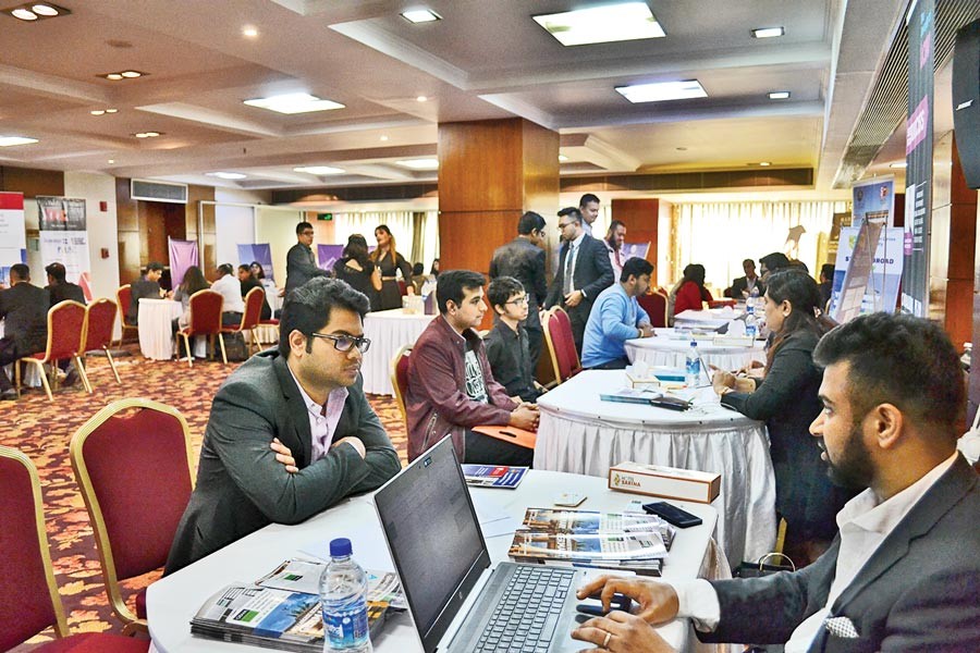 Visitors collecting information about various overseas institutions at the education fair organised by BEE Global Limited