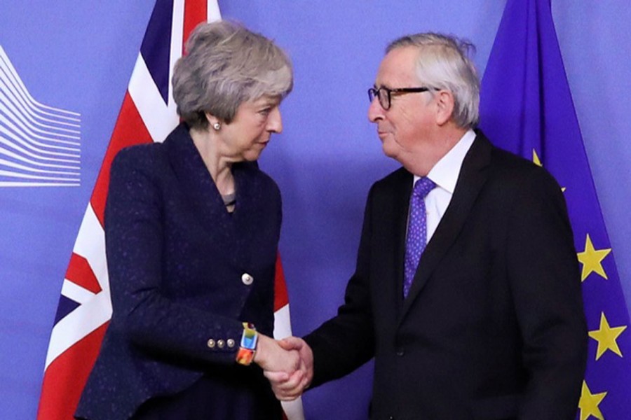 European Commission President Juncker shakes hands with British Prime Minister May in Brussels. Reuters