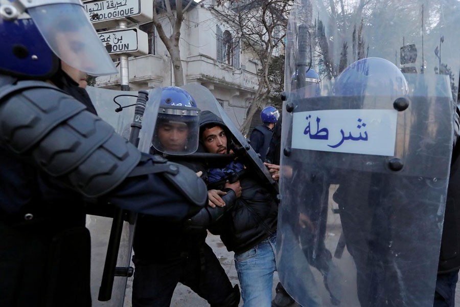 Anti-riot police officers detain a man who was protesting against President Abdelaziz Bouteflika's plan to extend his 20-year rule by seeking a fifth term in April elections in Algiers, Algeria, March 1, 2019 - REUTERS/Zohra Bensemra