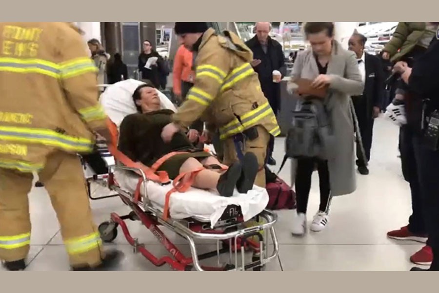 In this still image taken from video provided by WNBC-TV News 4 New York, emergency medical personnel tend to an injured passenger from a Turkish Airlines flight at New York's John F. Kennedy International Airport, Saturday, March 9, 2019 - WNBC-TV News 4 New York via AP