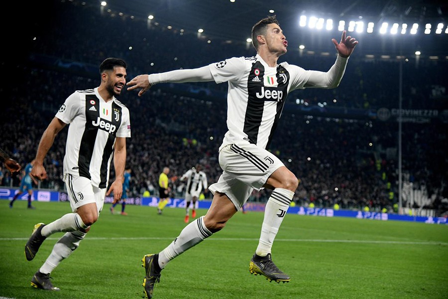 Juventus' Cristiano Ronaldo celebrates scoring their third goal to complete his hat-trick with Emre Can — Reuters photo