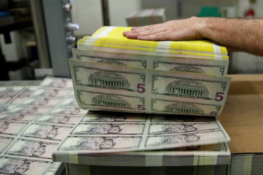 In this Reuters file photo, sheets of former US President Abraham Lincoln on the five-dollar notes are fanned out at the Bureau of Engraving and Printing in Washington.