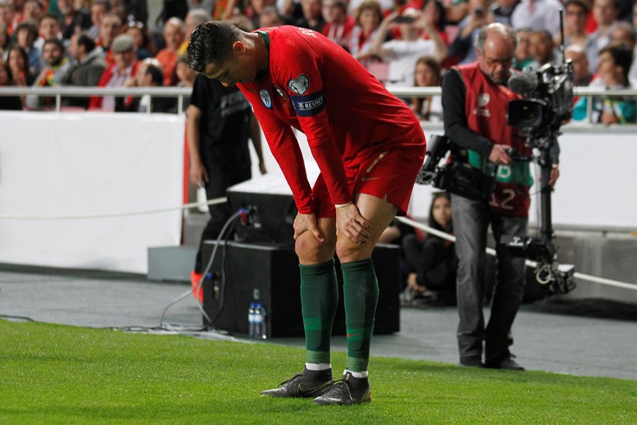 Portugal skipper Cristiano Ronaldo stands injured before being substituted off during the clash against Serbia on Monday — Reuters photo