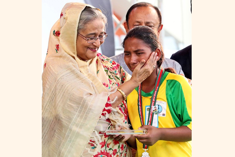 Prime Minister Sheikh Hasina consoling a player from runner-up team of the Bangamata Begum Fazilatunnesa Mujib Gold Cup Primary School Football Tournaments-2018 at Bangabandhu National Stadium in the city on Thursday	 	— BSS