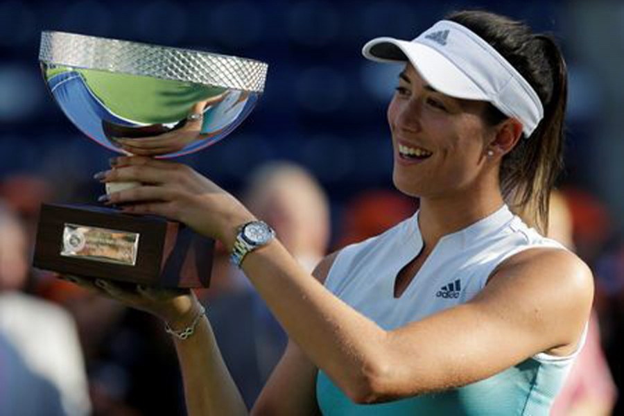 Spain's Garbine Muguruza holding the trophy after winning the Monterrey Open final on Sunday	— Reuters