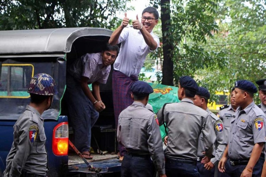 Detained Reuters journalists Wa Lone and Kyaw Soe Oo arrive at Insein court in Yangon, Myanmar August 27, 2018. Reuters/Files