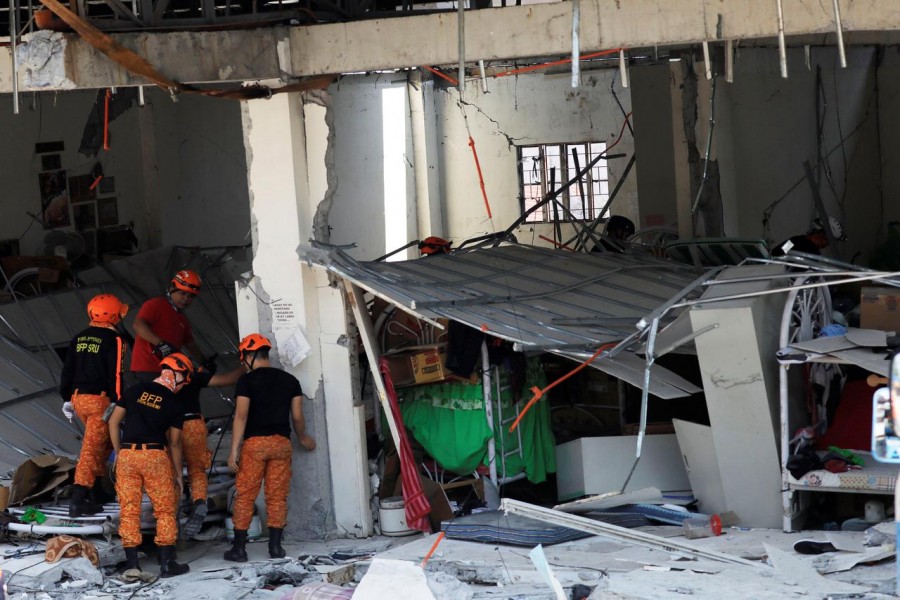 Rescuers are seen at a collapsed four-storey building following an earthquake in Porac town, Pampanga province, Philippines, April 23, 2019 - Reuters