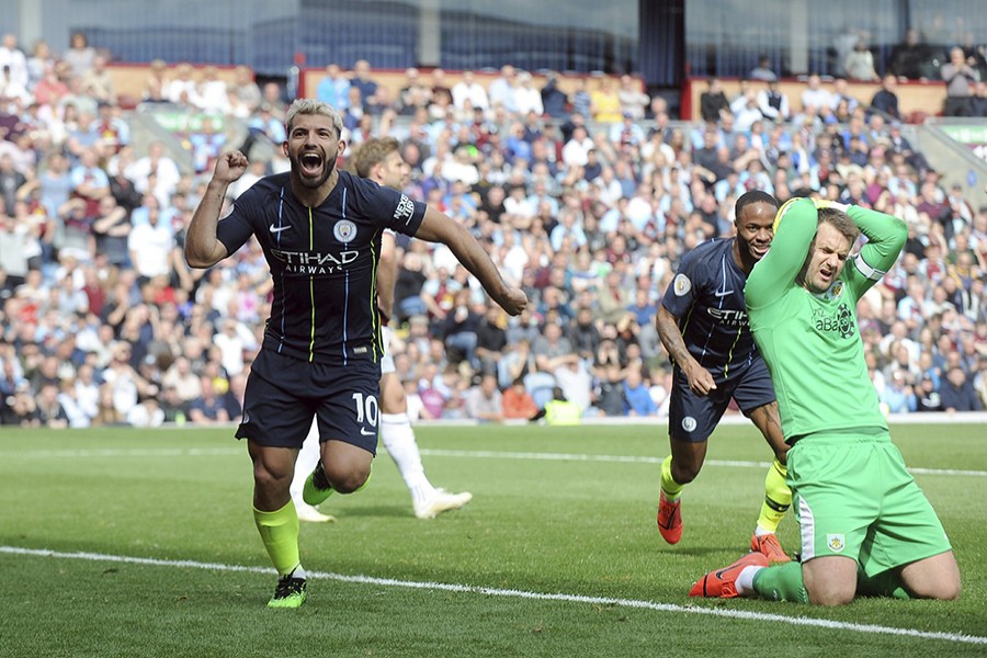 Manchester City's Sergio Aguero (L) celebrates after scoring his side's opening goal during the clash against Burnley at Turf Moor on Sunday — AP photo