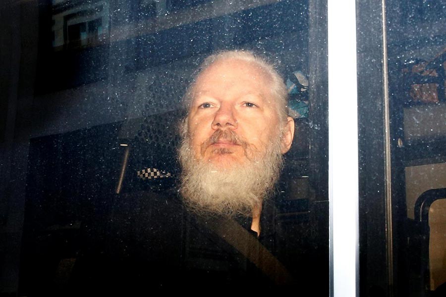 WikiLeaks founder Julian Assange was seen in a police van, after he was arrested by British police, in London on April 11. -Reuters Photo