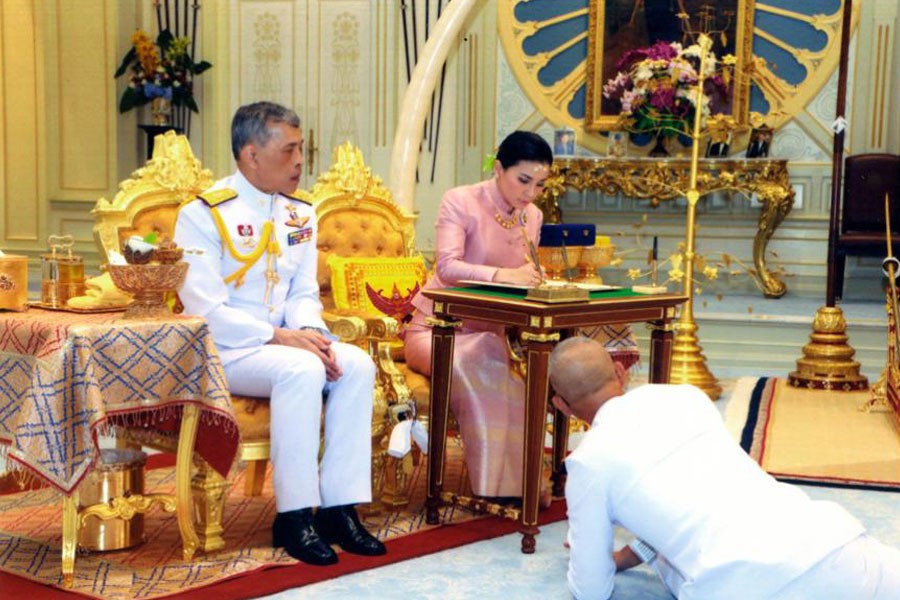 Thailand's King Maha Vajiralongkorn Bodindradebayavarangkun, sits with Queen Suthida Vajiralongkorn Na Ayudhya as they sign their marriage certificates at Ampornsan Throne Hall in Bangkok, Thailand - AP