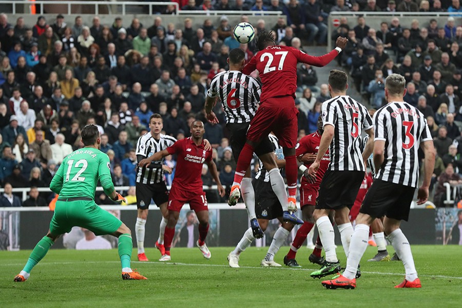 Liverpool's Divock Origi scores his side's third goal against Newcastle United — Reuters action image