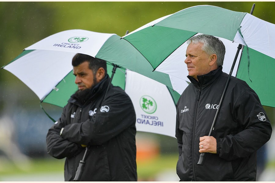 Umpires Aleem Dar and Mark Hawthorne taking shelter from the rain during the ODI match between Bangladesh and Ireland in Malahide on Thursday	— Internet