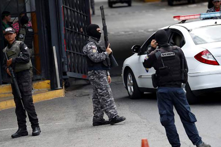 Members of the Bolivarian National Intelligence Service (SEBIN) stand guard outside a detention centre , where a riot occurred in Caracas, Venezuela - Reuters file photo used for representation