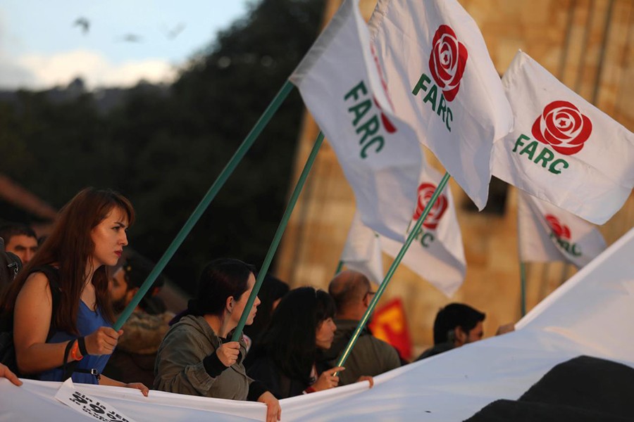 A woman holds a flag of the Revolutionary Alternative Force of the Common (FARC) political party during a protest in support of the Special Jurisdiction for Peace (JEP) in Bogota, Colombia on March 13, 2019 — Reuters photo