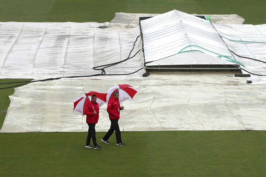 Umpires Richard Illingworth (right) and Richard Kettleborough inspect the field of play as it continues to rain at the ICC Cricket World Cup group stage match at the County Ground in Bristol, England on Tuesday, June 11, 2019. The Bangladesh side were scheduled to play with Sri Lanka on the day, but the match was later abandoned without a boll being bowled after persistent rain in the city — AP photo