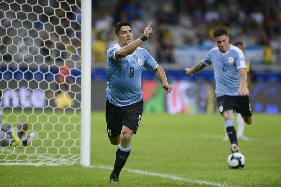 Uruguay's Luis Suarez celebrates after scoring their third goal shortly during the clash against Ecuador on Sunday — AP photo