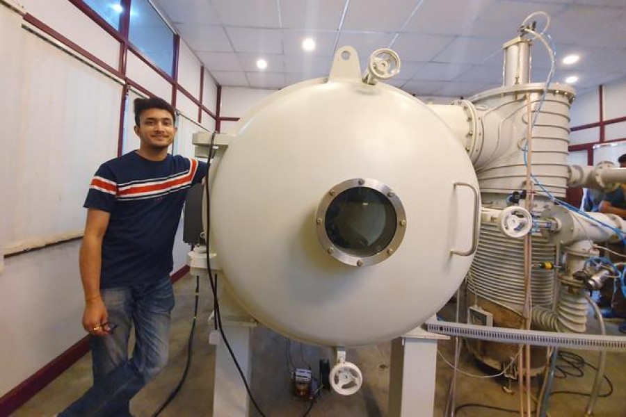 Bellatrix Aerospace CEO Rohan Ganapathy stands next to a vacuum chamber at their laboratory in Bengaluru, India, June 22, 2019. Reuters