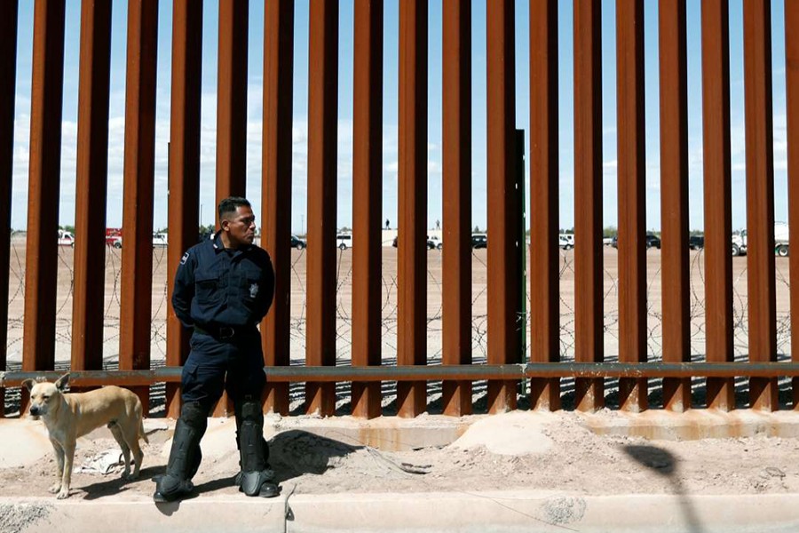 A Mexican federal police member stands guard during the visit of US President Donald Trump to Calexico, California as seen from Mexicali, Mexico on April 5, 2019 — Reuters/Files