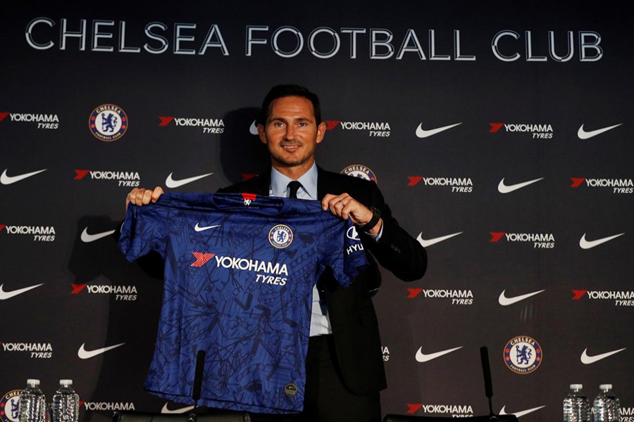 New Chelsea manager Frank Lampard holds up a shirt during the press conference — Reuters photo