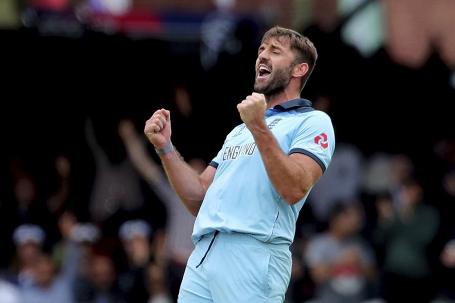 England's Liam Plunkett celebrates the dismissal of New Zealand's James Neesham — AP photo