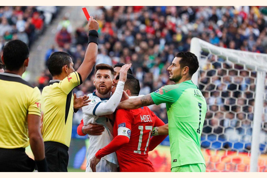 File photo: Argentina's Lionel Messi and Chile's Gary Medel scuffling as referee Mario Diaz, from Paraguay, left, shows the red card to both of them during Copa America third-place football match at the Arena Corinthians in Sao Paulo, Brazil 	— AP