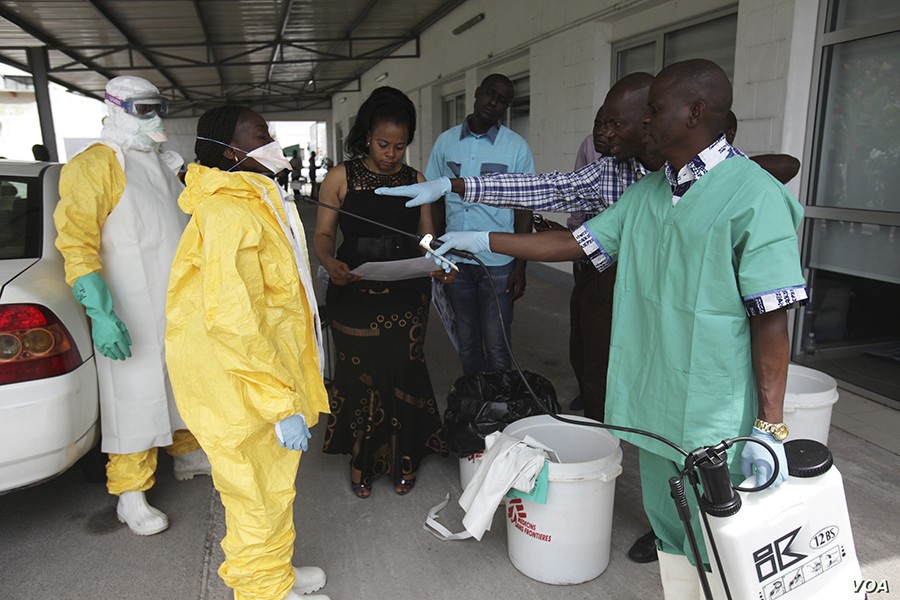 A health worker sprays a colleague with disinfectant during a training session for Congolese health workers to deal with Ebola virus in Kinshasa — Reuters/Files