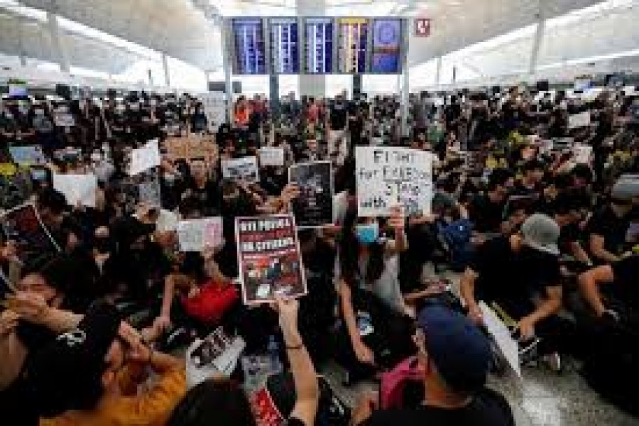 Protesters throng Hong Kong airport again after it reopens