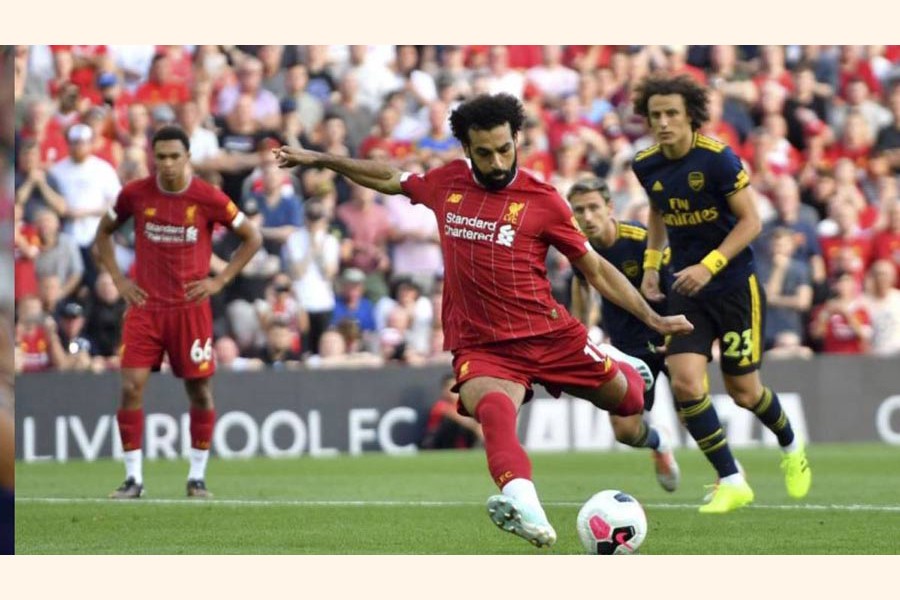 Liverpool's Mohamed Salah scored his side's second goal of the game from the penalty spot during the English Premier League football match against Arsenal at Anfield in England on Saturday 	— AP