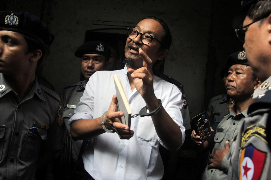 Filmmaker Min Htin Ko Ko Gyi is escorted out by police after a court hearing in Yangon, Myanmar, August 29, 2019. REUTERS/Myo Kyaw Soe