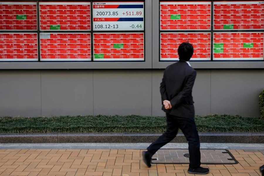 A man looks at an electronic board showing the Nikkei stock index outside a brokerage in Tokyo, Japan, January 7, 2019. Reuters/Files