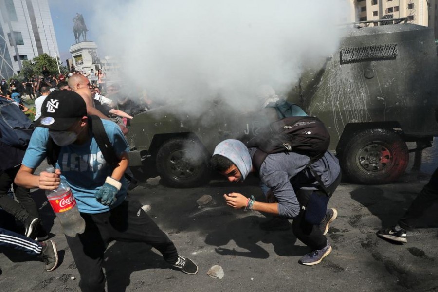 Protesters flee from tear gas during a protest against Chile's state economic model in Santiago October 20, 2019. REUTERS/Ivan Alvarado