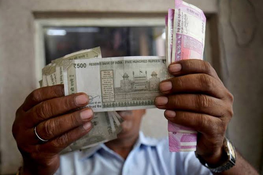 A cashier checks Indian rupee notes inside a room at a fuel station in Ahmedabad, India, September 20, 2018. Reuters/Files