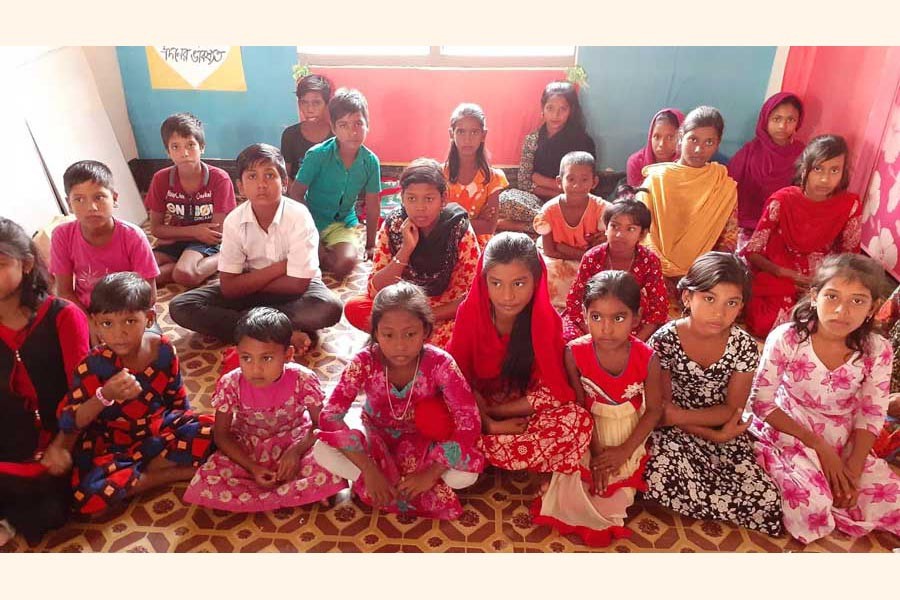 Left-behind children attend a class on non-formal education by OKUP at Char Shalepur : FE Photo