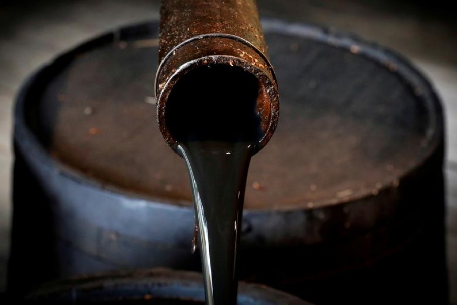 FILE PHOTO: Oil pours out of a spout from Edwin Drake's original 1859 well in Titusville, Pennsylvania U.S., October 5, 2017. REUTERS/Brendan McDermid