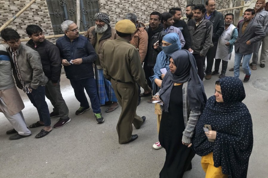 Muslim women arrive to cast their votes at Shaheen Public School, the polling booth closest to the Shaheen Bagh protest where Muslim women have been protesting for weeks against a new citizenship law, in New Delhi, India, Saturday, Feb. 8, 2020.   (AP Photo/Rishabh R. Jain)