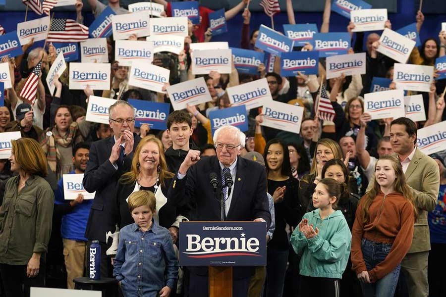 Senator Bernie Sanders is accompanied by his wife Jane O’Meara Sanders as he arrives to speak at his New Hampshire primary night rally in Manchester on Tuesday. -Reuters Photo