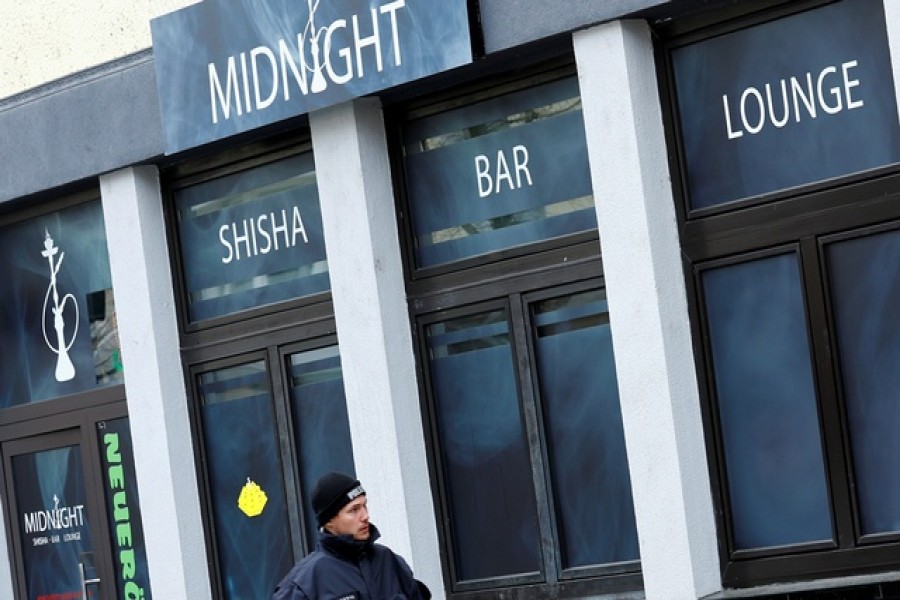 A police officer walks outside the Midnight Shisha bar after a shooting in Hanau, near Frankfurt, Germany, February 20, 2020. Reuters