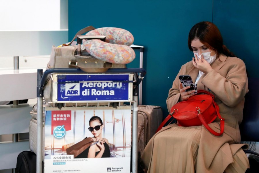 A passenger in a protective mask is seen at Rome's Fiumicino airport, after first cases of coronavirus were confirmed in Italy, January 31, 2020. REUTERS/Yara Nardi