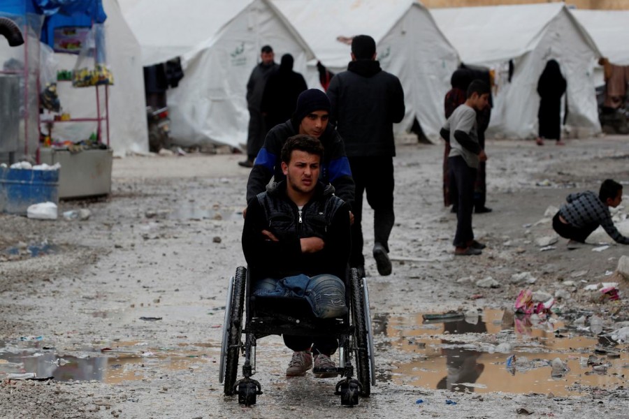 FILE PHOTO: Internally displaced Syrian is pushed in a wheelchair along the tents in an IDP camp located in Idlib, Syria February 27, 2020. REUTERS/Umit Bektas