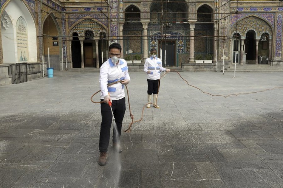 Workers disinfect the shrine of the Shiite Saint Imam Abdulazim to help prevent the spread of the new coronavirus in Shahr-e-Ray, south of Tehran, Iran, Saturday, March, 7, 2020 — AP Photo