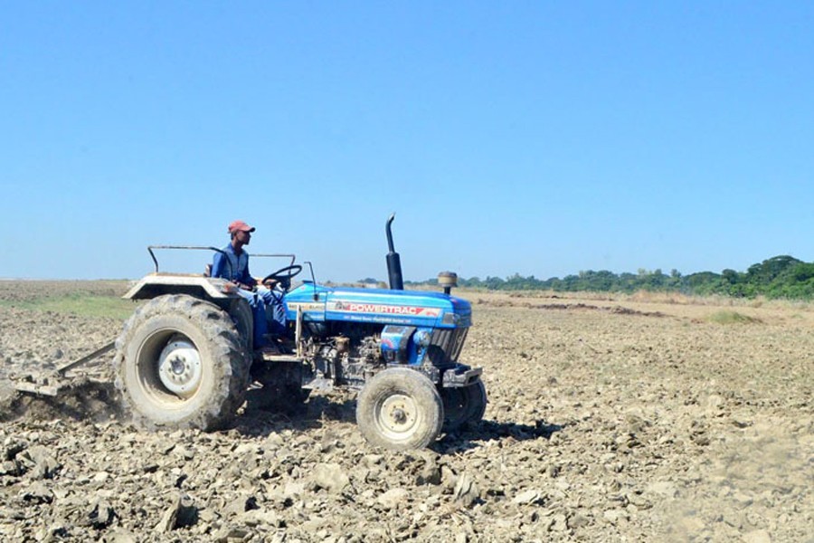 Representational image: A farmer is ploughing a piece of land by a tractor in Godagari upazila of Rajshahi, November 09, 2020. — FE Photo