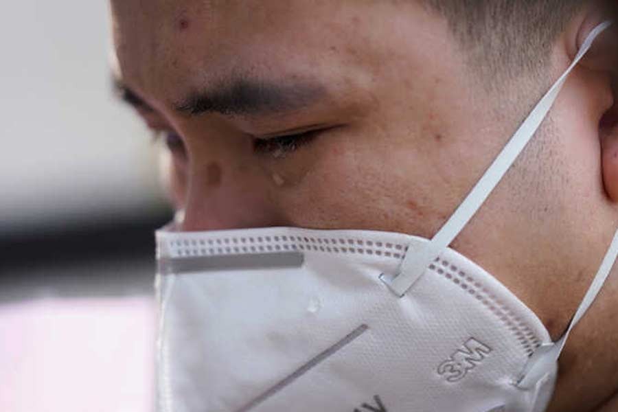 A man crying in Wuhan, Hubei province, as China holds a national mourning for those who died of the coronavirus disease (COVID-19), on the Qingming tomb-sweeping festival, on Saturday. –Reuters Photo