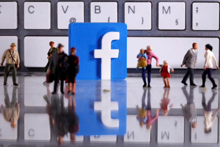 A 3D printed Facebook logo is placed between small toy people figures in front of a keyboard in this illustration taken on April 12, 2020 — Reuters