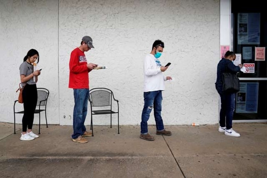 People who lost their jobs wait in line to file for unemployment following an outbreak of the coronavirus disease (COVID-19), at an Arkansas Workforce Centre in Fayetteville, Arkansas, US, April 06, 2020. — Reuters