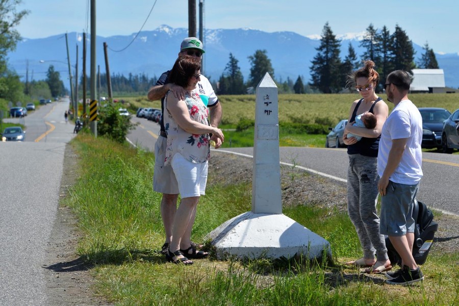 Daniel and Cheryl Sanchez, of Seattle, Washington, introduce their two week old baby to grandparents Rosemary and Roland Berezan of Surrey, during a roadside meet up along the Canada-U.S. border, closed to non-essential travel due to the coronavirus disease (COVID-19) restrictions as the family gathered for Mother's Day in Langley, British Columbia, Canada May 10, 2020. REUTERS/Jennifer Gauthier